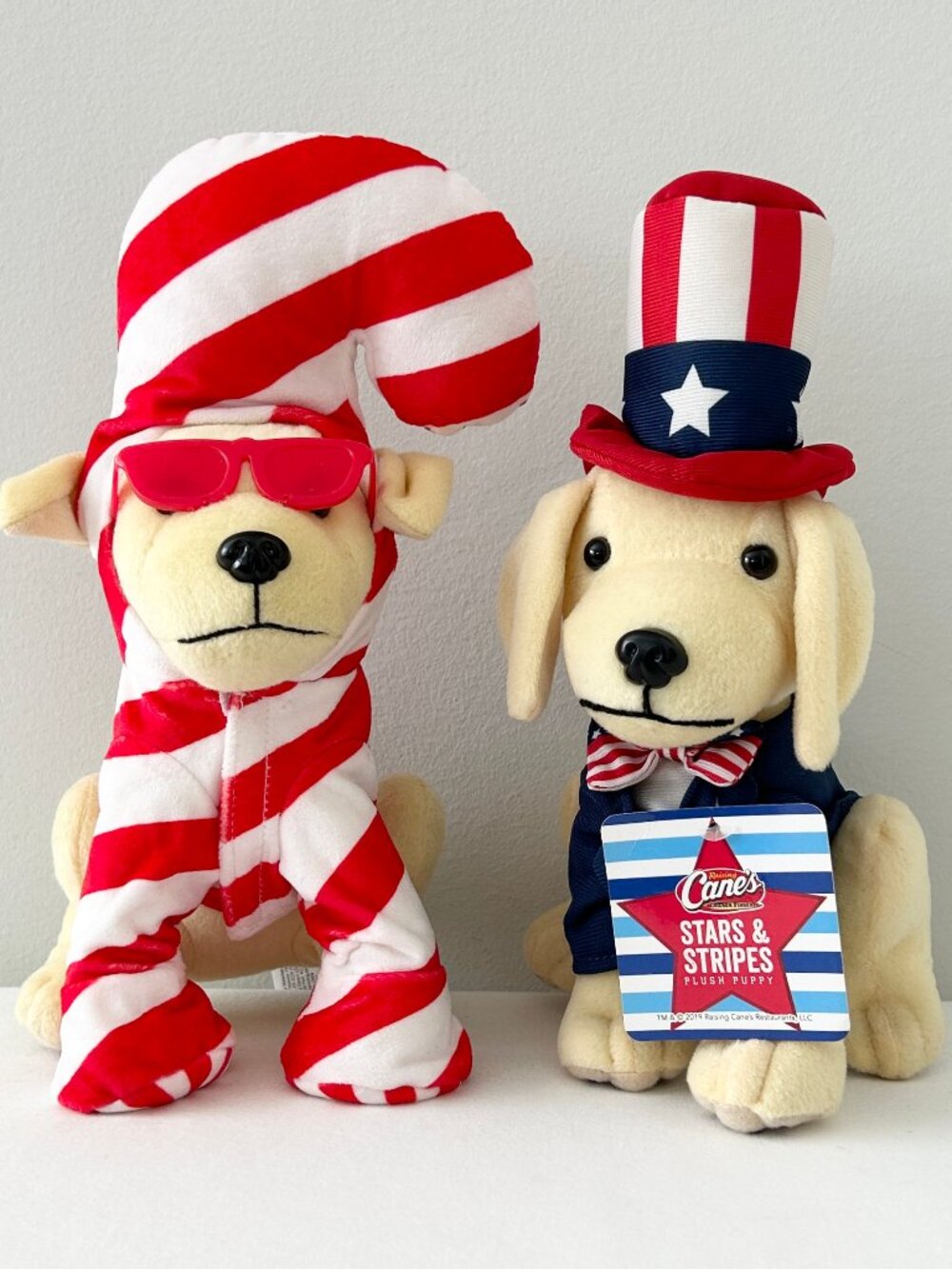 2 Raising Canes Dog Plush Candy Cane Christmas Stars Stripes Uncle Sam Patriotic